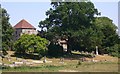 Bepton church and churchyard seen from Bugshill Lane in GU29 0HY