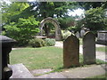 Tombs and archway in St Mary the Virgin Churchyard, Mortlake in SW14 8RD