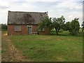 Boarded-up building in orchard in PE34 4BA
