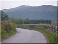 Graceful curve of the B846 Road flanked by drystane dyke in PH15 2LH