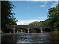 River Usk with canal aqueduct, road bridge and fisherman in LD3 7SN