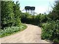Dirt track past water towers, Bentwaters in IP12 3PQ