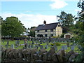 Longhope Churchyard, with historic building beyond in GL17 0LD