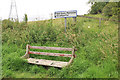 Ruined bench and sign for the Neil Gunn Memorial in IV15 9EB
