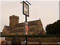 Coychurch: parish church of St. Crallo and White Horse pub sign in CF35 5EP