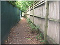 Footpath between residential gardens near Haste Hill in GU27 3TE