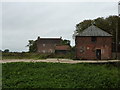 Boarded-up farm with outbuildings in IP29 4PB