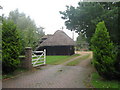 Thatched barn of Bliby Cottage in TN25 7JB