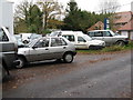 Cars on forecourt of repair centre in RH14 0UH