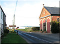 The Street past converted Methodist chapel, Marham in PE33 9JL