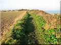 Approaching Heathland Beach Caravan Park on clifftop path in NR33 7PJ