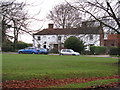View across village green to Plaistow Stores in RH14 0QD
