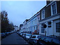 Pastel-coloured buildings on Denbigh Road in W11 4EH