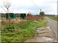 Green huts beside Boughton Road in PE33 9HF