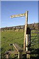 A stile and signpost for Birrens Roman Fort in DG11 3LJ