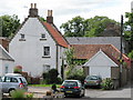 Houses beyond the market cross in Coldingham in TD14 5PY