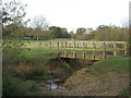 The River Ravensbourne and footbridge in Norman Park in BR2 9PF