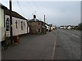 Road through Cheriton Cross, with old toll house in EX6 6HY