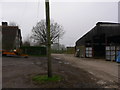 Farmyard with footpath signs in GU28 0NX