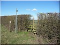Footpath sign and stile in Thistleton