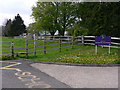Footpath sign and stile by Duncton School in Duncton