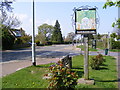B1332 The Street, Framingham Earl & Framingham Earl Village sign in NR14 7XW