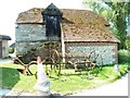 Restored barn and farm machinery at New House in BN6 9JF