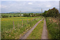 The lane towards Freezeland Farm with Winter Hill beyond in BL6 5SX
