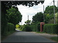 Road passes the phone box in Long Crichel in BH21 5LD