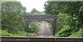 Stone railway bridge viewed across a cast-iron aqueduct, Resolven in SA11 4LS
