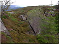 Huge crack in the angled rock layer of the 'quarry' north of Beinn Bhreac in FK8 3XJ