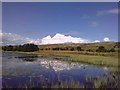Doe's Loch in the foreground with a Cumulonimbus cloud forming in the distance in KA6 7RF