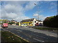 Police car and 87 bus outside yellow painted shop on Herries Road in S5 7BE