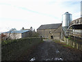 The public footpath entering Sunny Bank farmyard in LA8 9BU