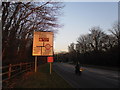 Motorcyclist passing a road sign in Bartons Road in PO9 5NA