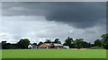 Cheshire pasture, converted barns and heavy clouds in CW7 4DR