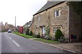 Stone cottage and phonebox in Kingham in OX7 6UQ