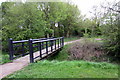Footbridge over a stream at the edge of Old Farm Park in MK17 8YU