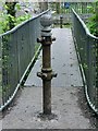 Disused turnstile posts on Lower Clydach River footbridge in SA6 5YL