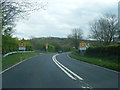A483 at College Bridge and Derwydd village boundary sign in SA19 6PU