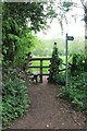 Stile and signpost off Mill Lane in GL54 4EP