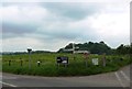 Signpost and lush meadow at minor road junction near Wiseburrow Farm in TA21 0LZ