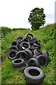 Tyres fly-tipped on track south of Hawthorn Fields in S80 3EQ