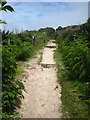 The coast path leading away from the beach car park at Sennen Cove in TR19 7AY