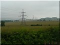 Pylons march across arable land in NE66 4SY