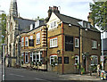 The Stag Public House with Trinity Church on the left in EN1 1YT