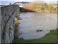 Swollen River Severn under Caersws road bridge. in SY17 5DX