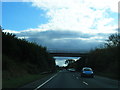 A533 passes under bridge to New Hall Farm in CW9 8LA