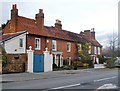 Terrace of red-brick cottages, in the Broadway, Laleham in TW18 2SP