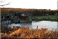Dilapidated farm buildings and icy waterlogged field in LU7 3DY